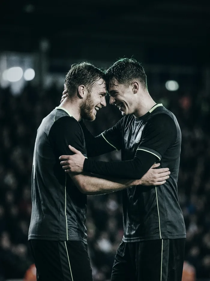 Dois jogadores da mesma dupla comemorando juntos, testa com testa, depois de um gol